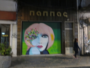 Thomai passing beautiful storefront one blurry night in Ioannina, Greece; October 2014.